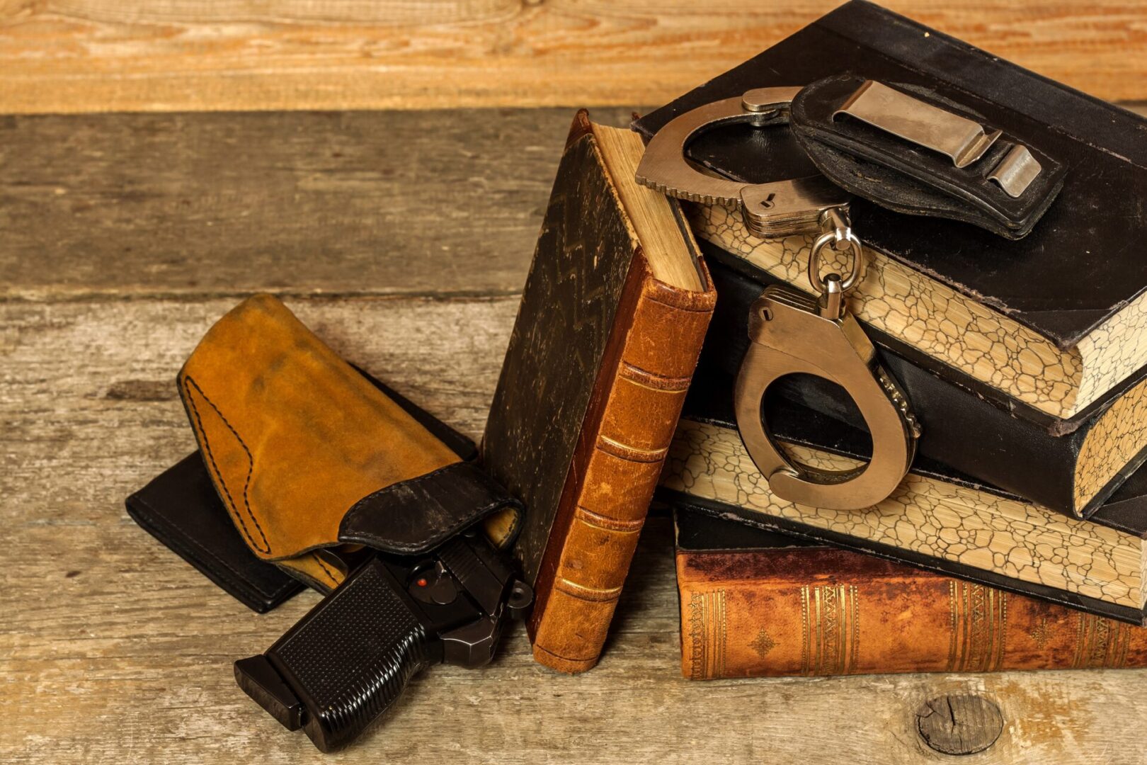 Vintage books with handcuffs and gun